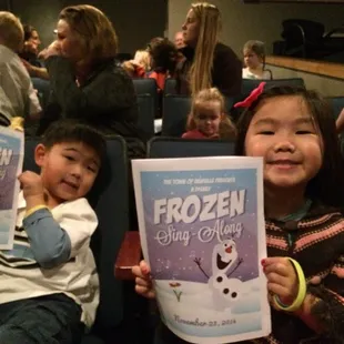 There are some very excited kids waiting for the Frozen Sing-a-long to start and The Village Theater!