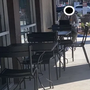 a person sitting at a table outside