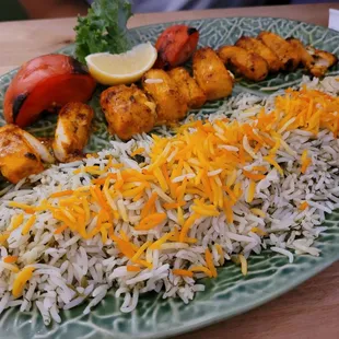 a plate of rice, chicken, and vegetables