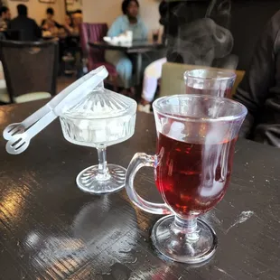 a cup of tea and a spoon on a table