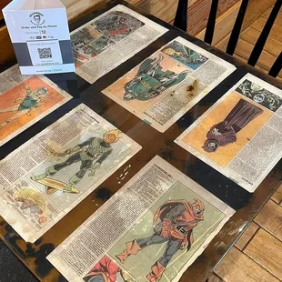 a table with a bunch of comic books on it