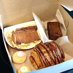 (Clockwise from top left) tiramisu, brownie, chocolate croissant, wedding cookies