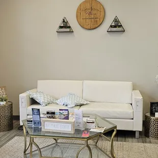 a living room with a white couch and coffee table