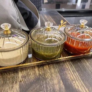 Sauces: white is yogurt?/mayo/sour cream with herbs, green is cilantro/jalapeno &amp; the red is a habanero.  They are all tasty!