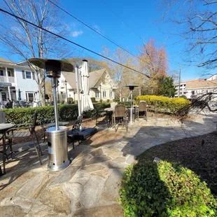 a patio with tables and umbrellas