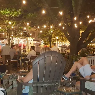 a group of people sitting outside at night