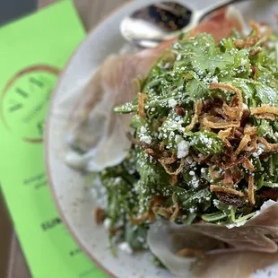ARUGULA &amp; PROSCIUTTO SALAD Arugula, Prosciutto, Goat Cheese, Crispy Shallots, White Balsamic Vinaigrette
