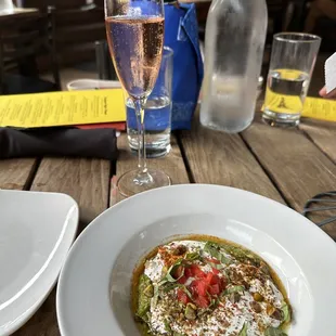 a plate of food and a glass of wine