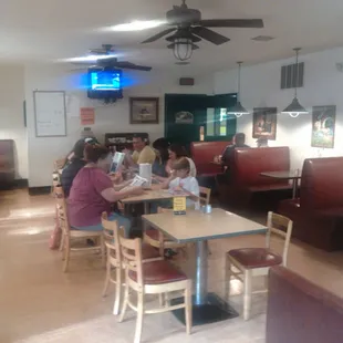 people sitting at tables in a restaurant