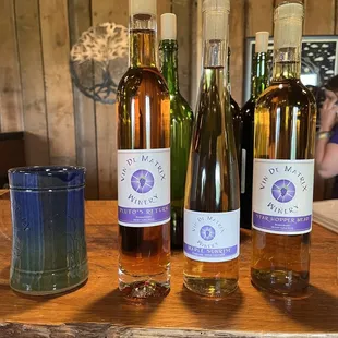 three bottles of wine on a table