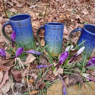 three blue mugs with purple flowers