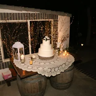 We set up the cake table using two of their barrels and brought in a slab of wood and some twinkle light twigs for the back drop.
