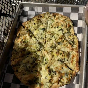 Spinach artichoke pizza with lime chicken.