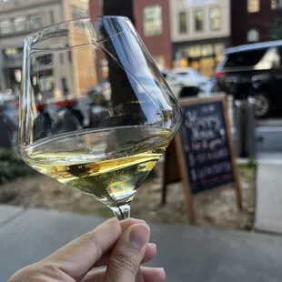 a person holding a glass of wine
