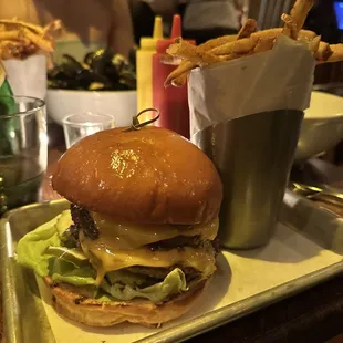a hamburger and fries on a tray