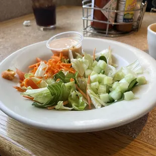 a plate of salad and a cup of coffee