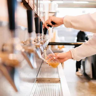 a person pouring wine into a glass