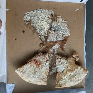 Undercooked underside of pizza.  As you can see it stuck terribly to the cardboard the leftovers were placed on.  Yeah, raw dough does that.