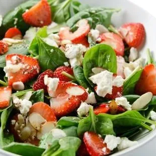 Fresh Spinach with Strawberries, Feta Cheese,  Green Onions &amp; Toasted Almonds, with a wonderful Vinaigrette Dressing.