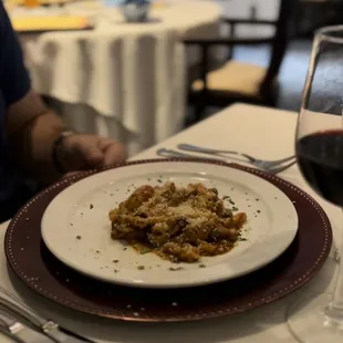 a plate of pasta and a glass of wine