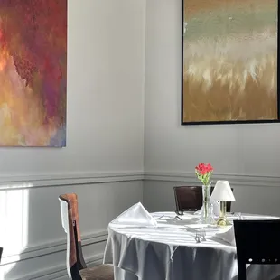 a dining room with a table and chairs