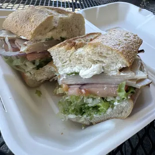 Turkey, cream cheese, onion, lettuce, tomato on a sourdough roll