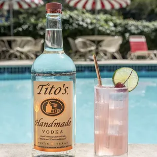 a bottle of vodka next to a cocktail glass