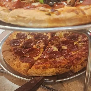 Combo and pepperoni pizzas .