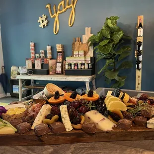 a platter of cheese, meat, and fruit