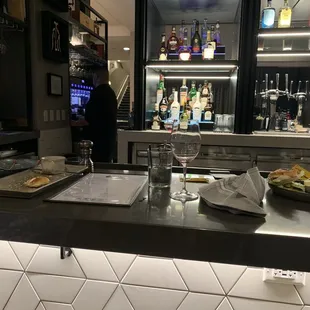 Dishes not cleared after end of meal at bar.