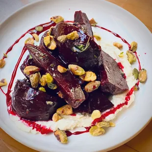 a plate of food with sauce and nuts