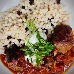 a plate of food with rice and meatballs