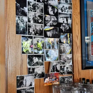 a wall of photos and wine glasses
