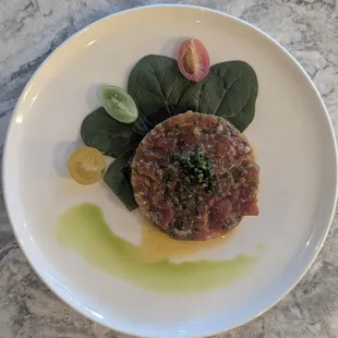 Kimchi Beef Tartar with spinach and heirloom tomatoes.