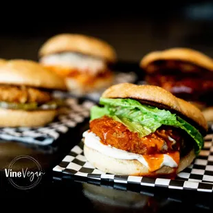 three burgers on a checkered tray