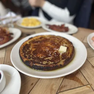 a plate of pancakes and a cup of coffee