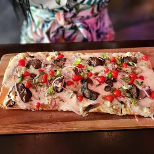 a pizza on a cutting board