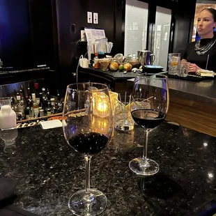 two glasses of wine on the bar
