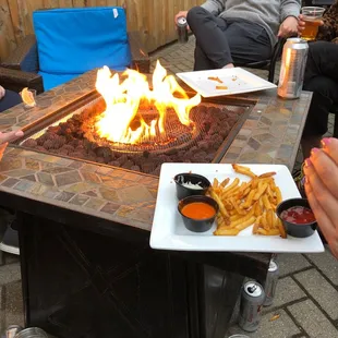 people sitting around a fire pit