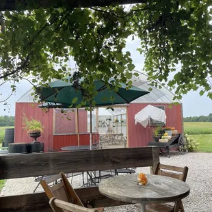 a table and chairs under an umbrella