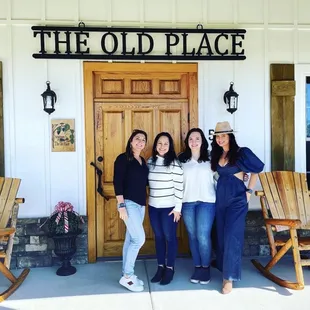 three women standing in front of the winery