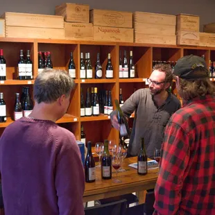 Beaujolais natural wine producer Romain des Grottes showing his wines to customers.