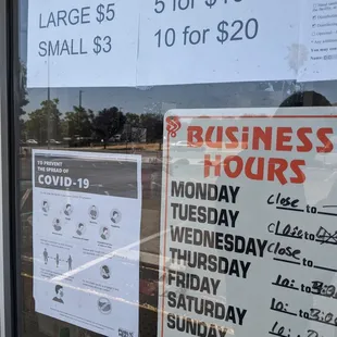 COVID protocol signs posted outside the window