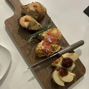 Crostinis (left to right) with shrimp, chicken, and apple with fig.
