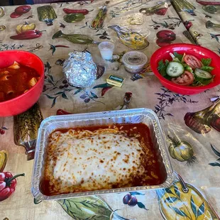 Chicken parmigiana, salad, pasta, dinner roll
