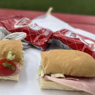 two sub sandwiches on a table