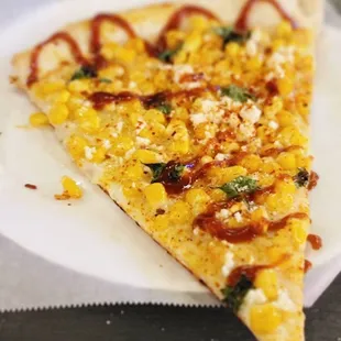 a slice of pizza on a paper plate