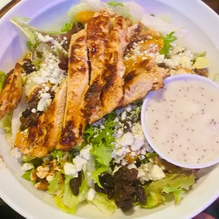 a salad with chicken and dressing