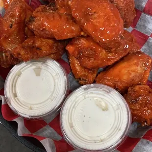 a basket of wings and dips
