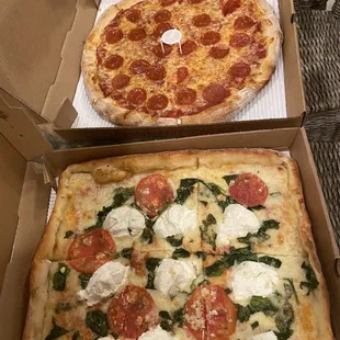 two pizzas in boxes